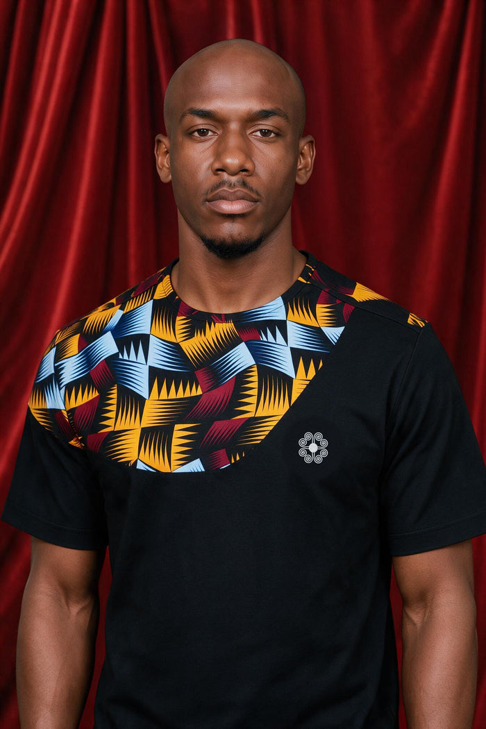 Mike wearing the black Nala panel tee with a white Chepa chest emblem.