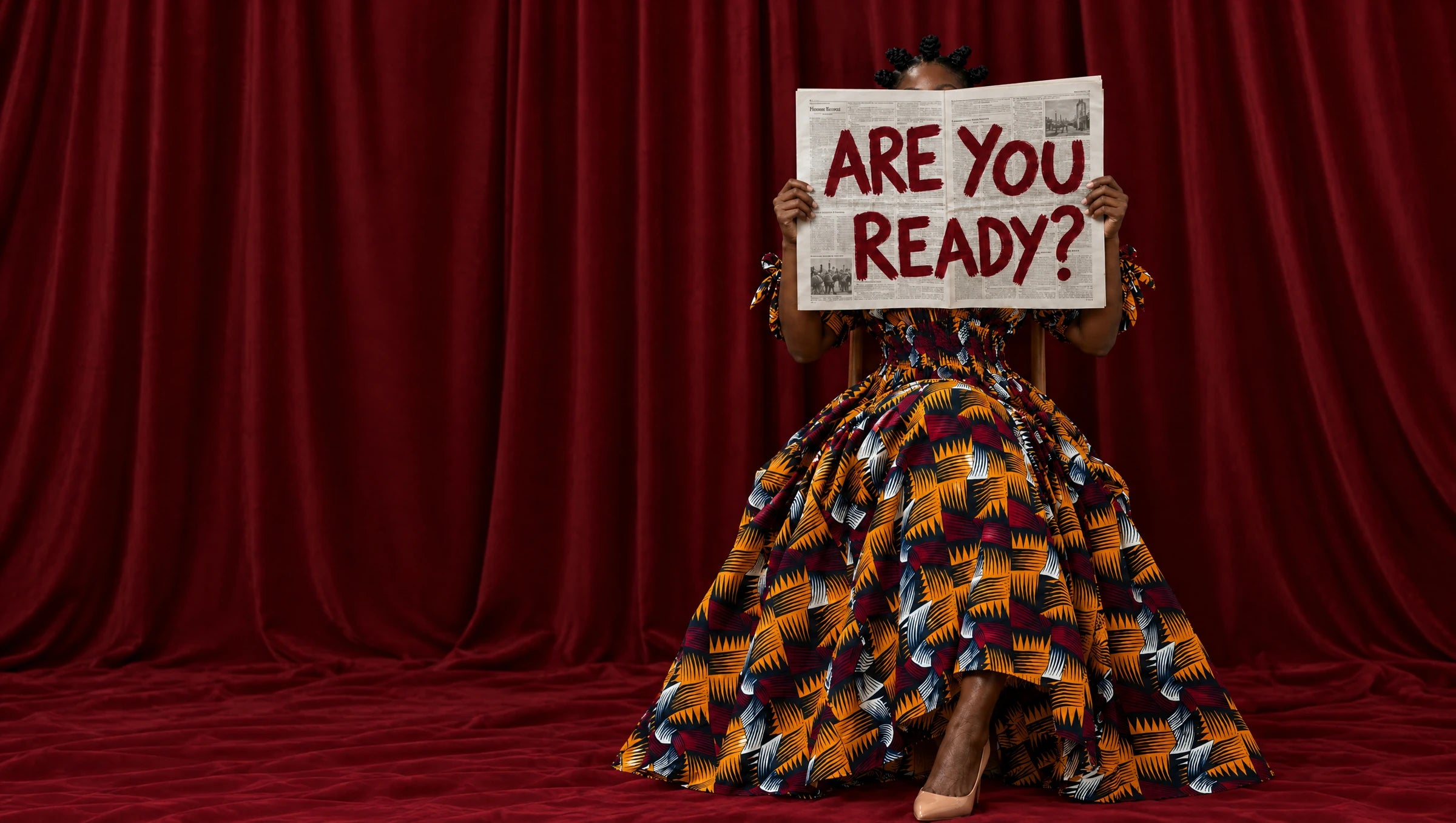 Model in the Nala dress surrounded by red curtains