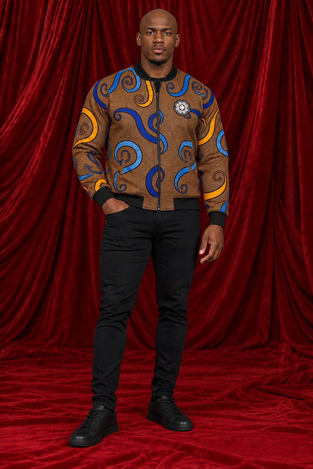 Full-length view of the Chepa Mpho Print Bomber Jacket in brown with blue and gold swirls
