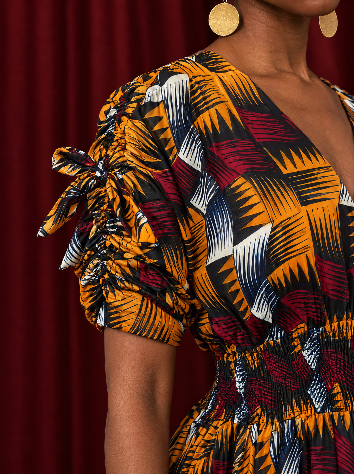 Close-up of Nala's ruched sleeve, outer sleeve tie and cotton Ankara print.